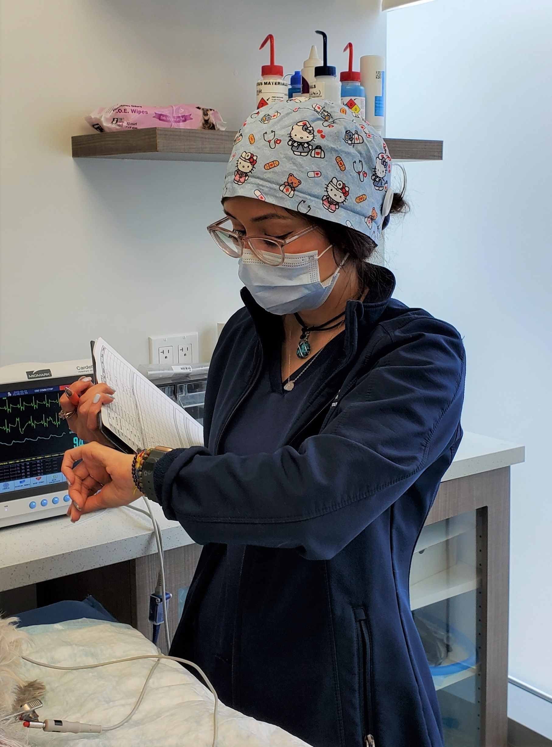 Staff member checking the time on the watch.