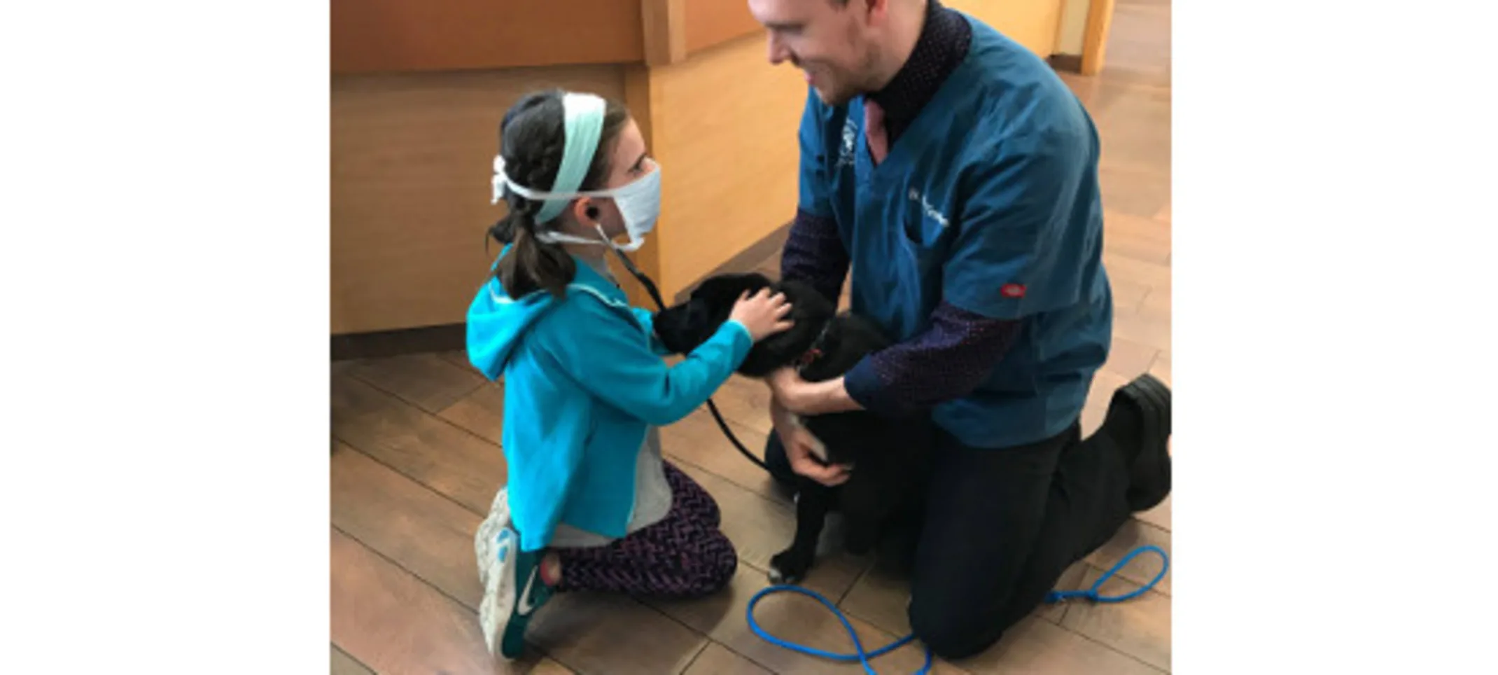 Staff showing girl a dog