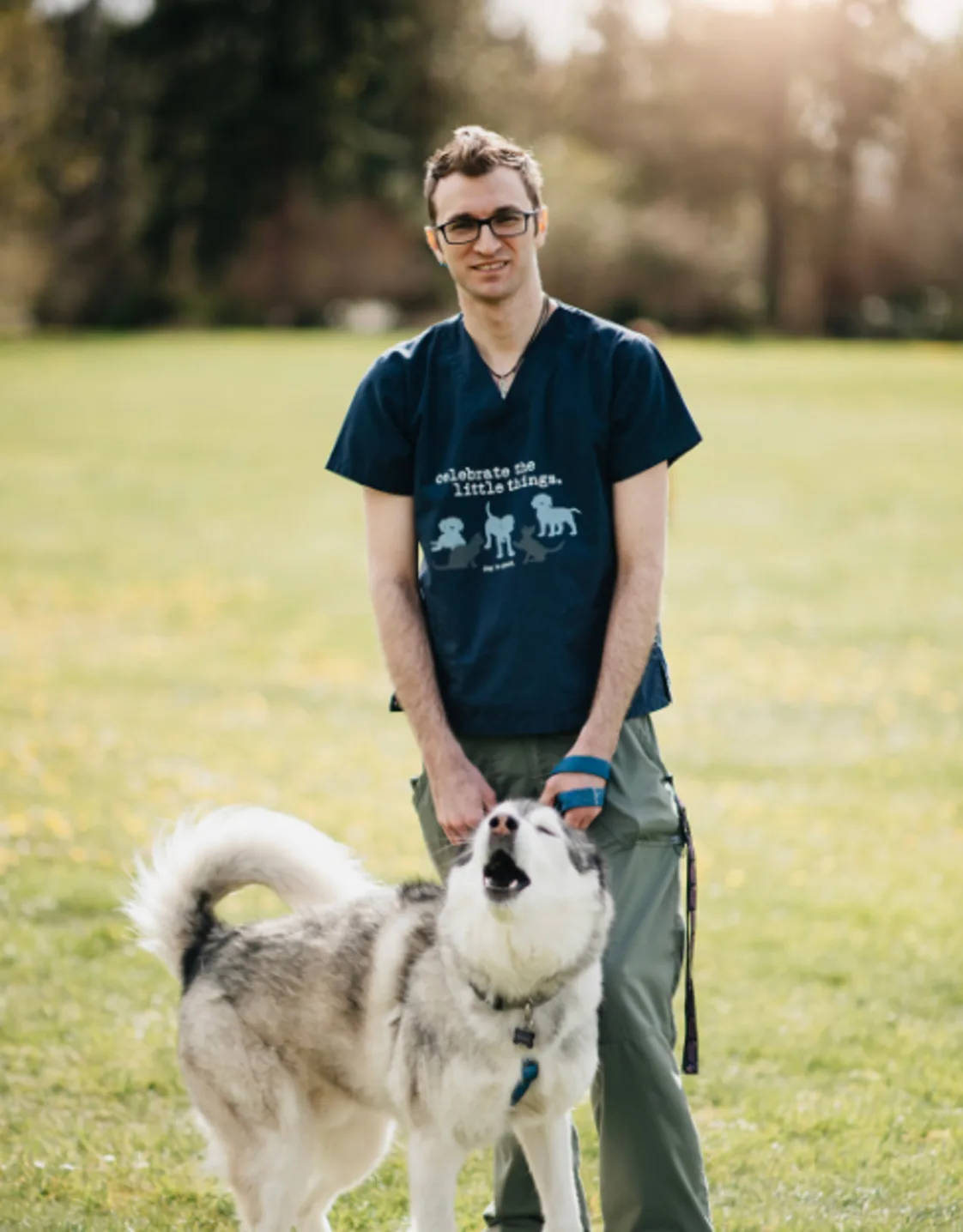 Weston Scott standing with a husky on a leash Weston Scott standing with a husky on a leash