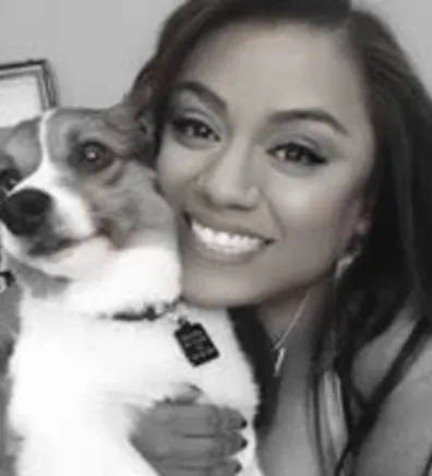 Kali Pearl holding a small dog. Kali Pearl holding a small dog.