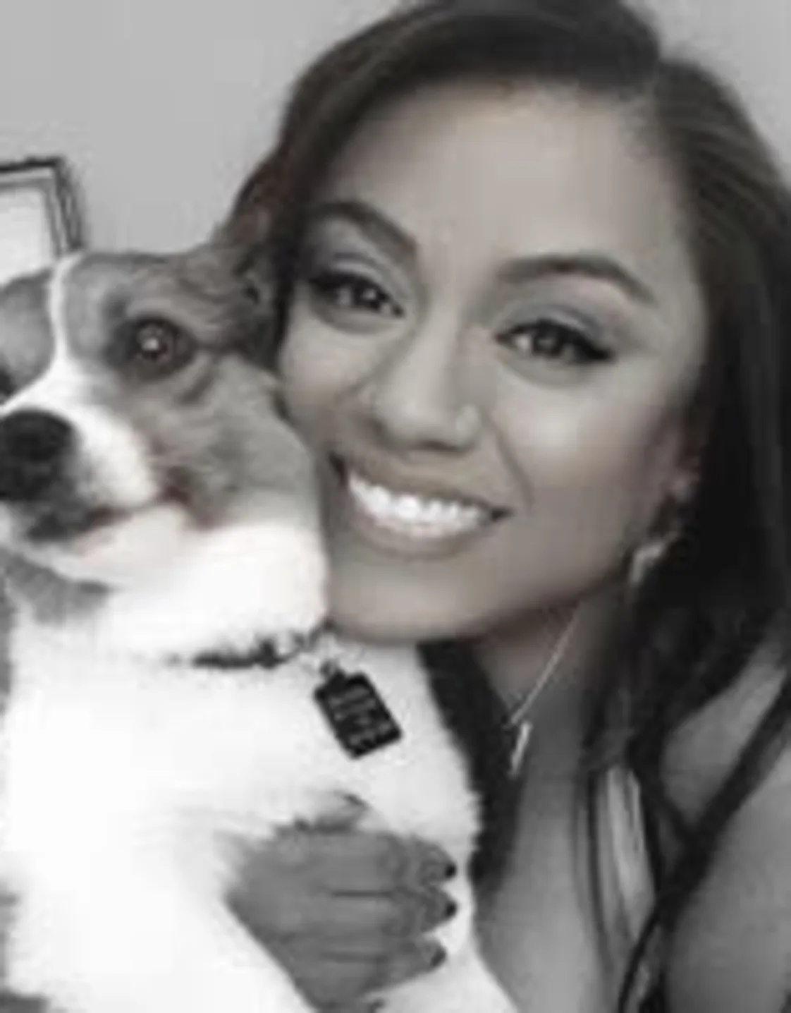 Kali Pearl holding a small dog. Kali Pearl holding a small dog.