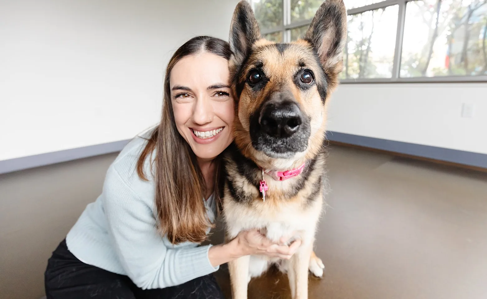 Smiling woman hugging a dog Smiling woman hugging a dog