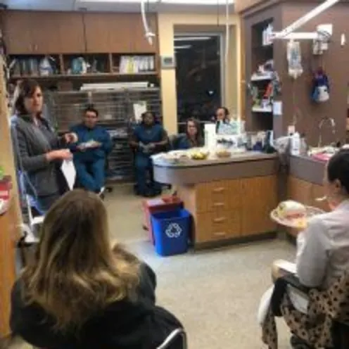 A veterinary professional standing up while talking to an audience