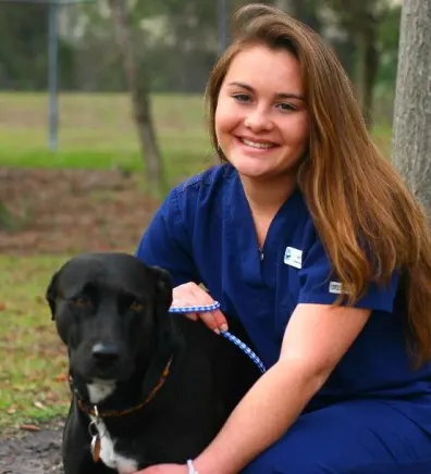 Jenna H. staff photo with dog outsdie