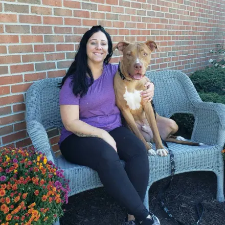 Kettering Animal Hospital's Megan L posing with a dog