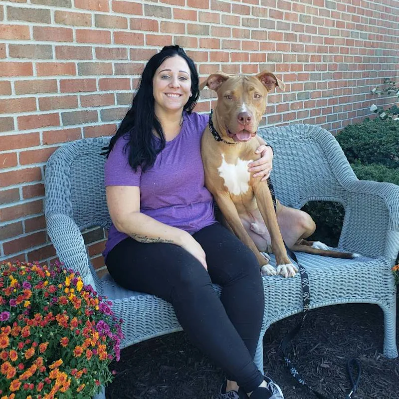 Kettering Animal Hospital's Megan L posing with a dog Kettering Animal Hospital's Megan L posing with a dog