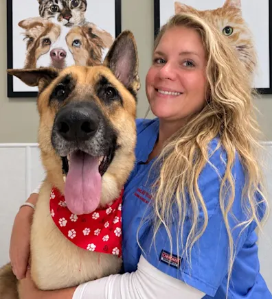 Jessica's staff photo from Spanish Trail Animal Hospital where she is outside on the lawn posing for a picture with a black dog next to her. Jessica's staff photo from Spanish Trail Animal Hospital where she is outside on the lawn posing for a picture with a black dog next to her.