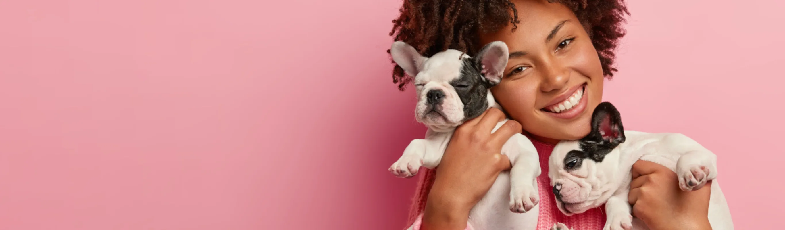 Woman Holding Two Puppies - Pink Background