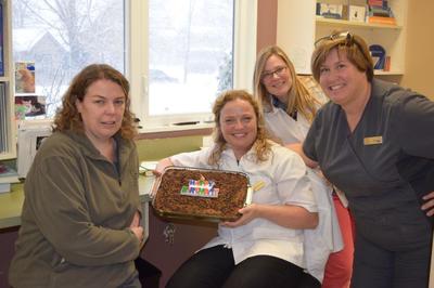 Vets posing with cake