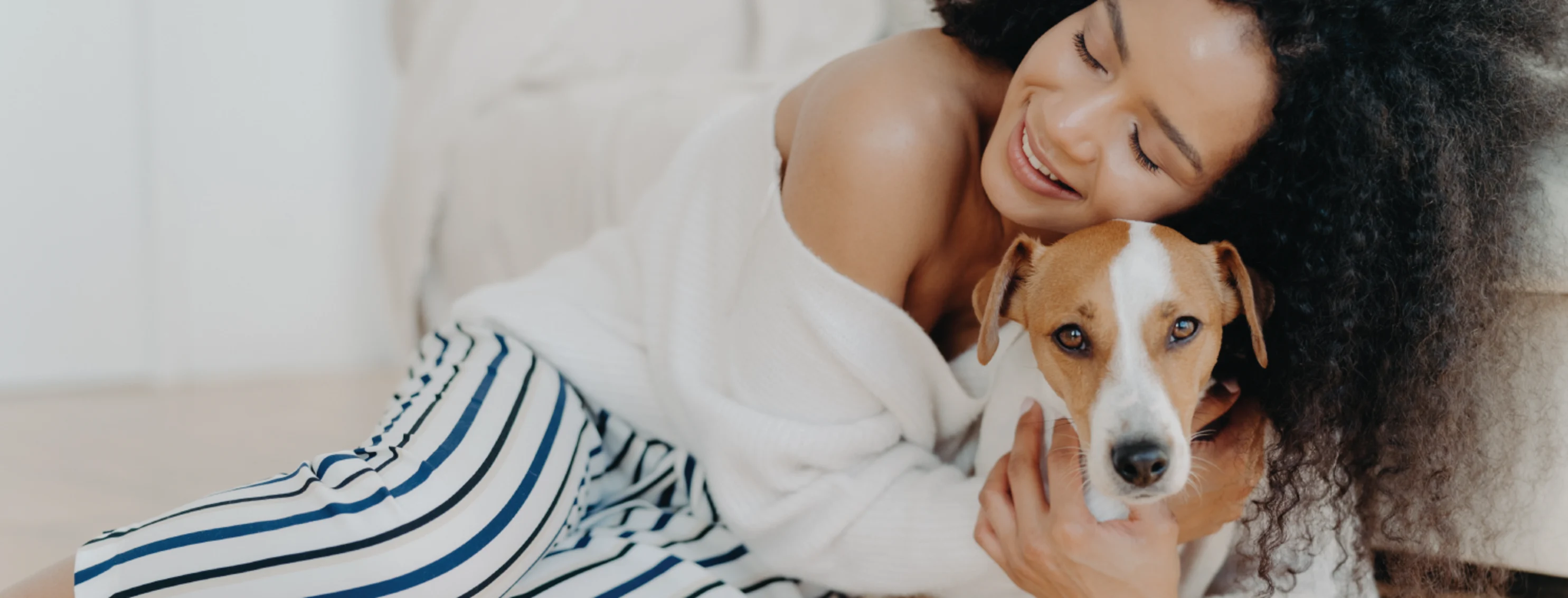 Woman Hugging Dog on Floor