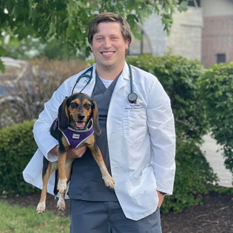 Joseph Dobbins holding a small dog outside Joseph Dobbins holding a small dog outside