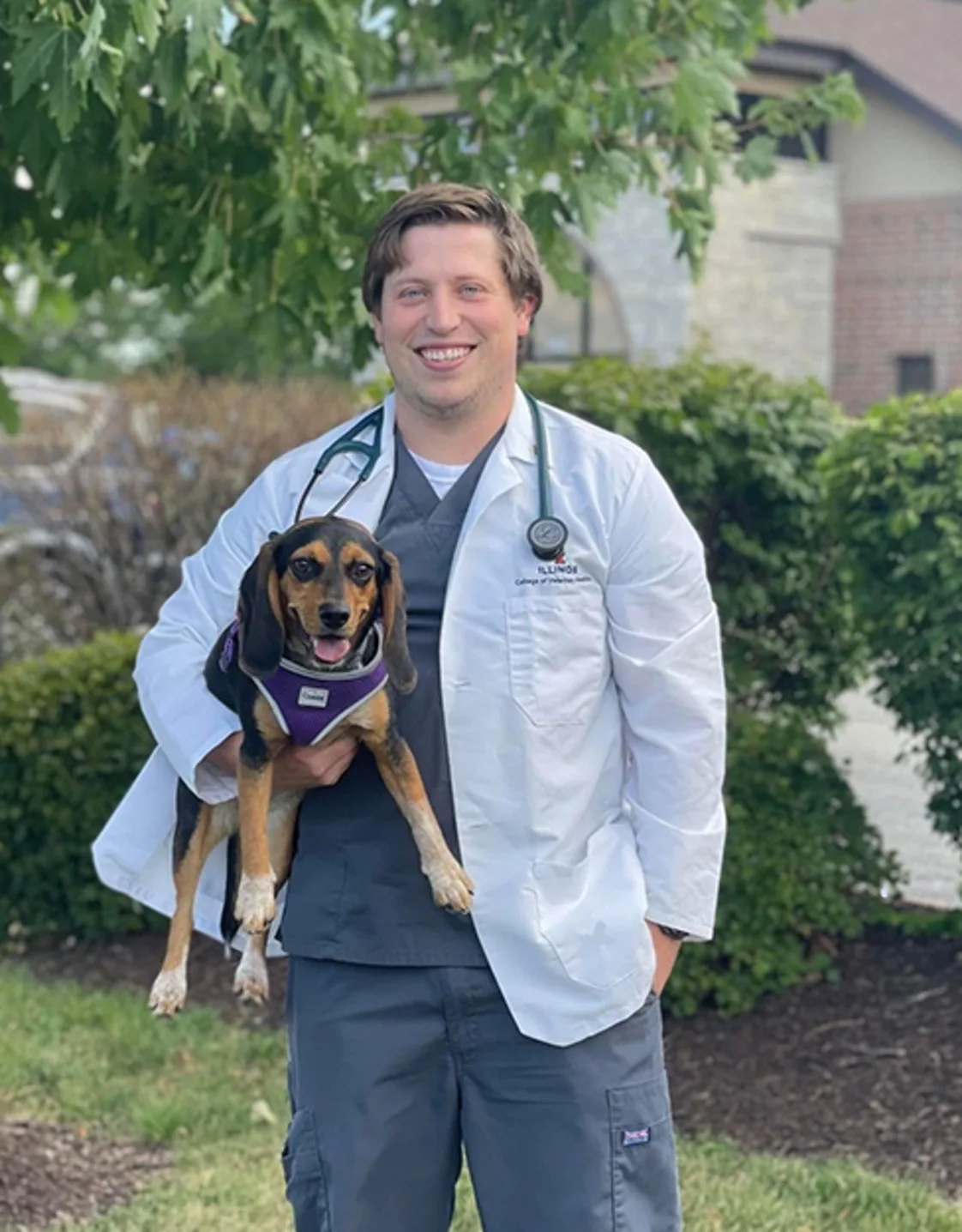 Joseph Dobbins holding a small dog outside Joseph Dobbins holding a small dog outside