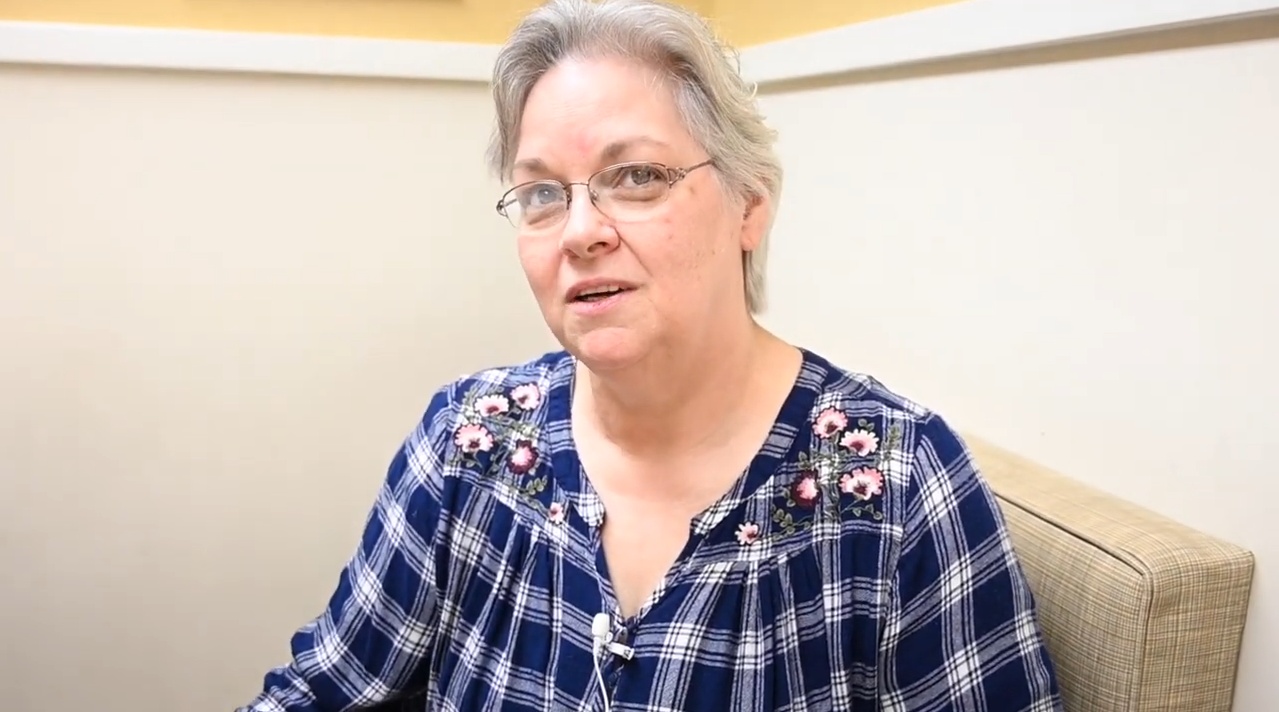 Woman in a blue plaid blouse.