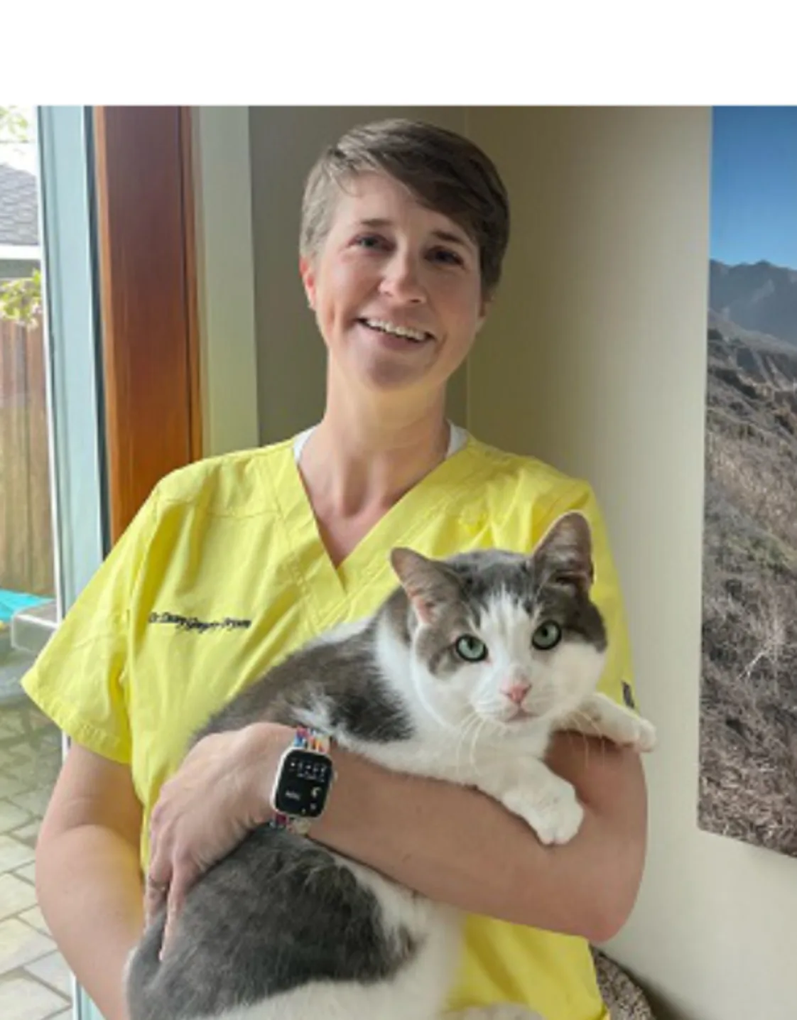 Dr. Emmalena Gregory-Bryson holding onto a large cat. Dr. Emmalena Gregory-Bryson holding onto a large cat.