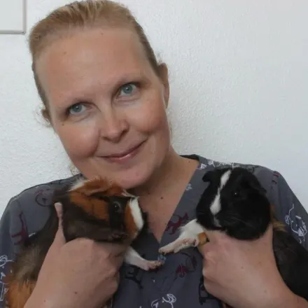 Emma Scott holding a pair of guinea pigs.