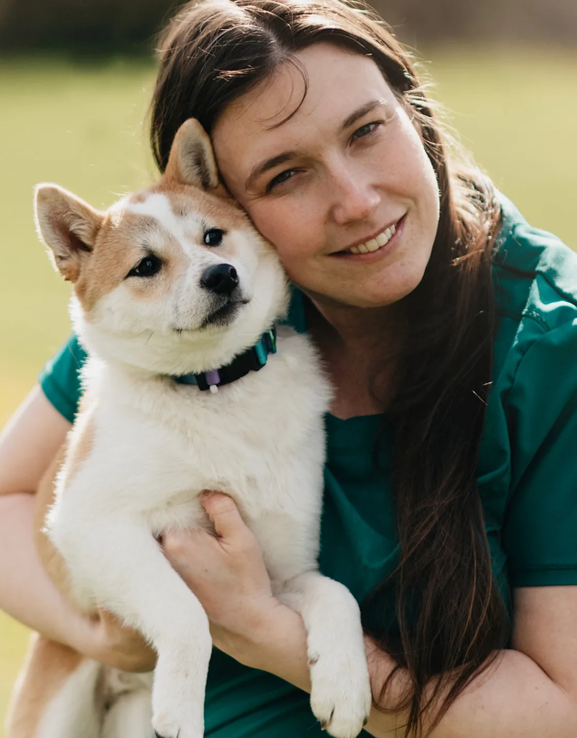 Dr. Danielle Kepler holding a tan and white Shiba Inu dog Dr. Danielle Kepler holding a tan and white Shiba Inu dog