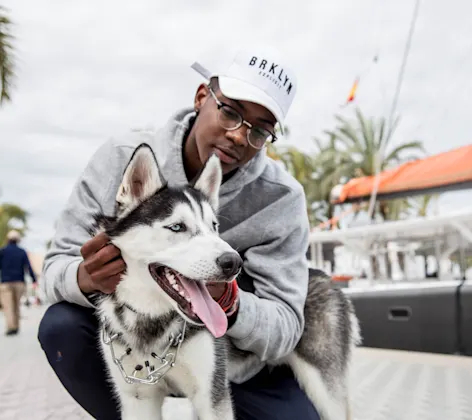 Man holding dog by the dock Man holding dog by the dock