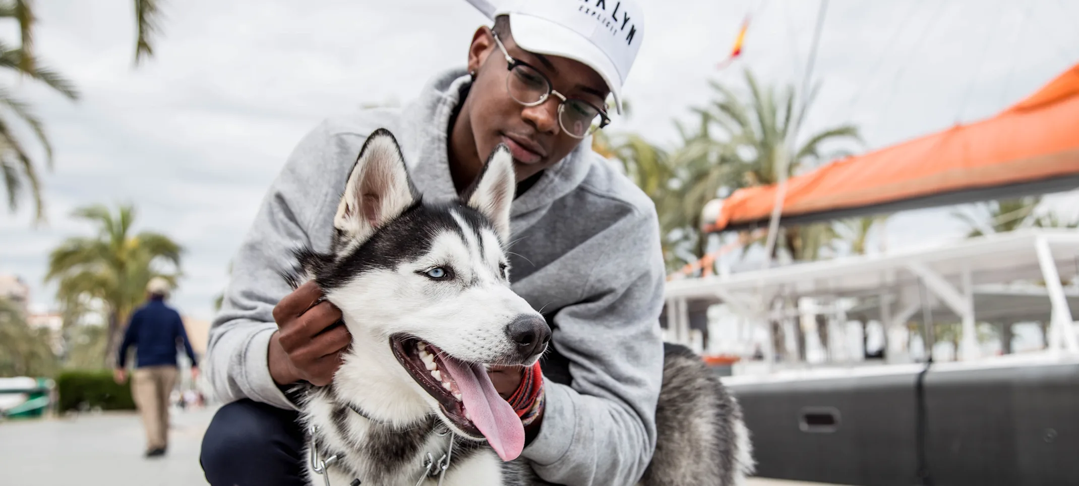 Man holding dog by the dock Man holding dog by the dock