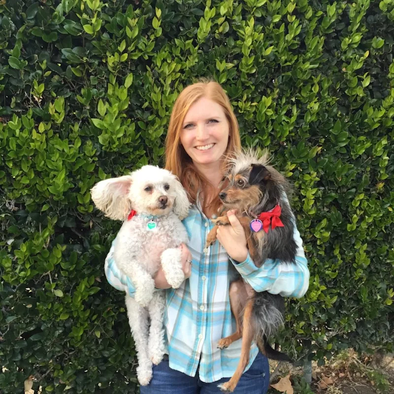 Dr. Leslie Healis holding two dogs. Dr. Leslie Healis holding two dogs.