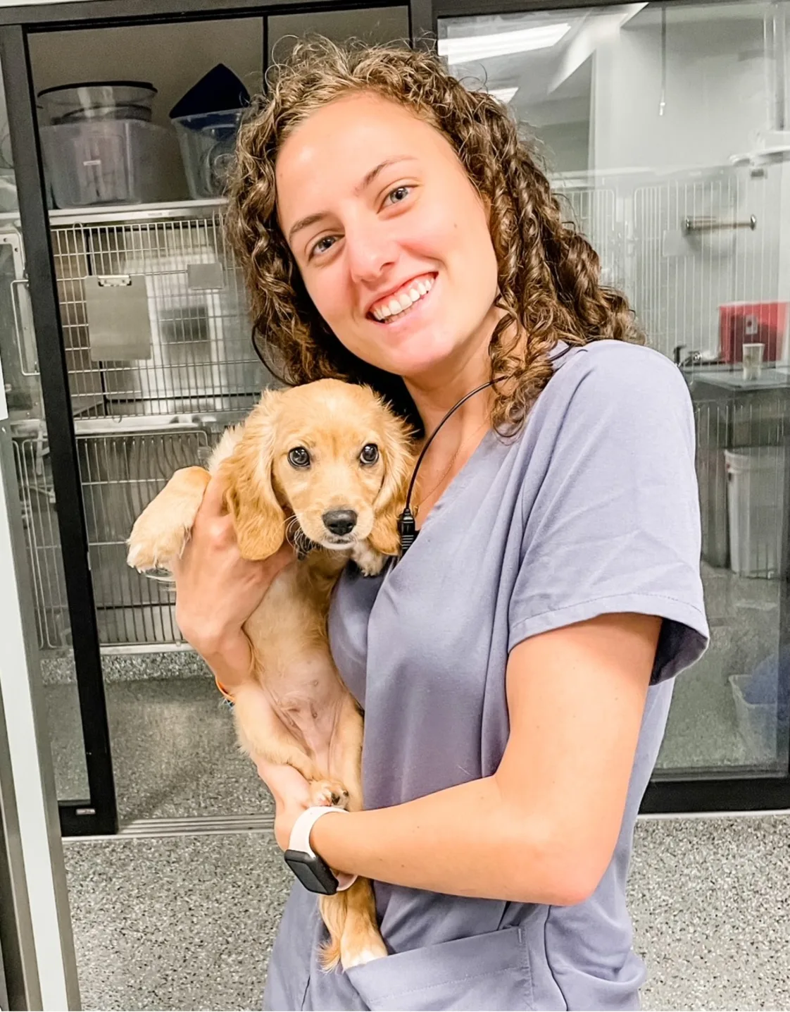 Makenna Baldwin smiling holding a puppy Makenna Baldwin smiling holding a puppy