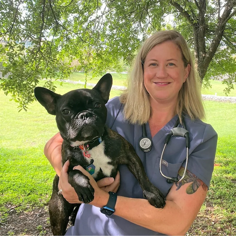 Dr. Jennifer Bucher smiling next to large dog Dr. Jennifer Bucher smiling next to large dog