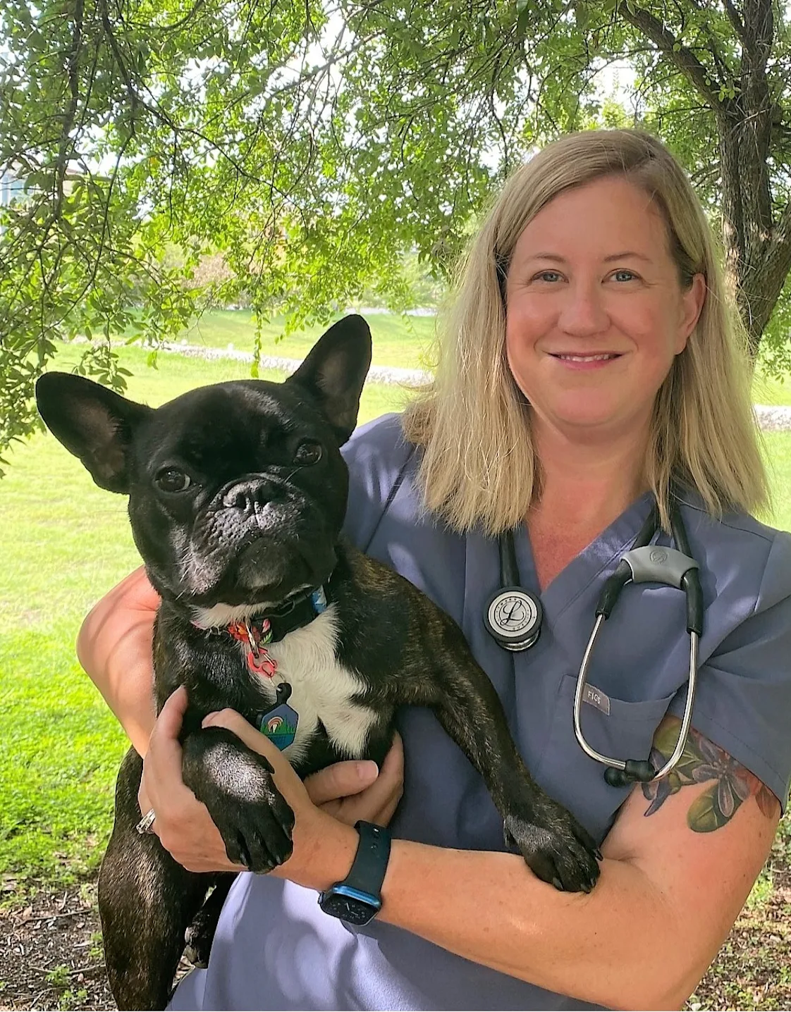 Dr. Jennifer Bucher smiling next to large dog Dr. Jennifer Bucher smiling next to large dog