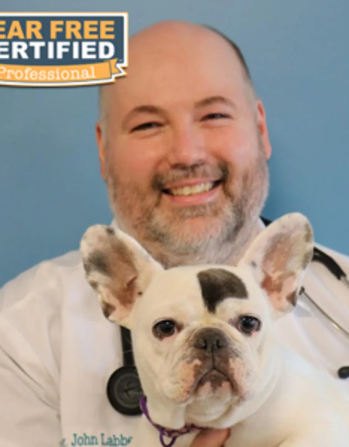 Dr. John Labbe holding a dog Dr. John Labbe holding a dog
