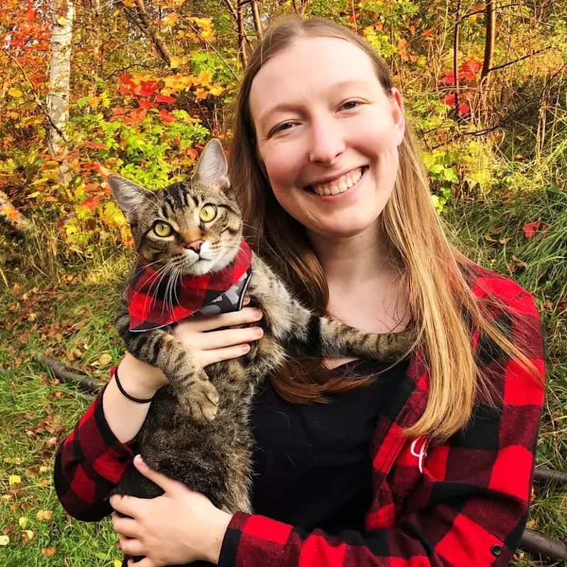 Staff photo of Dr. Cassia Michel holding a cat Staff photo of Dr. Cassia Michel holding a cat
