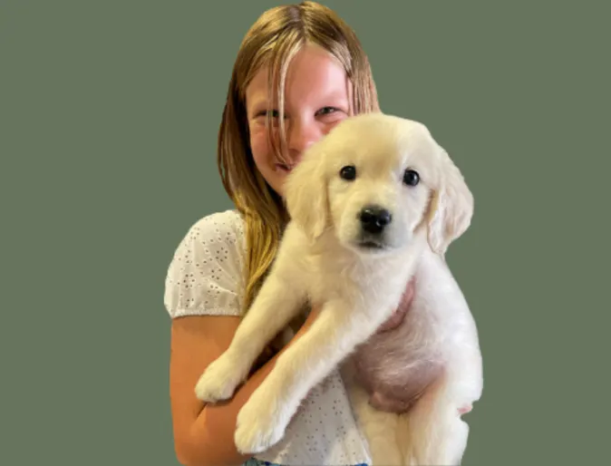 A girl holding a dog.