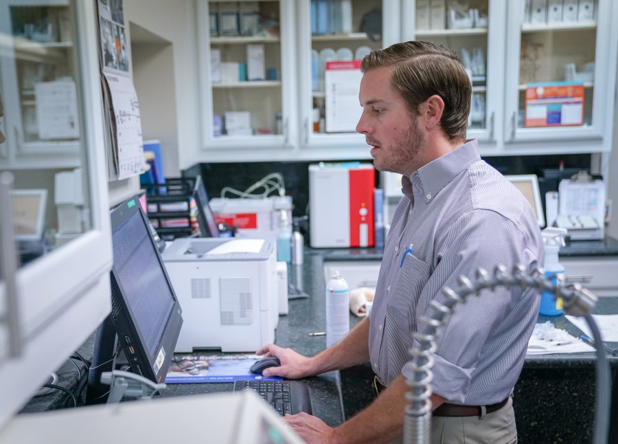 Veterinarian on computer in laboratory at Hill Country Animal Hospital