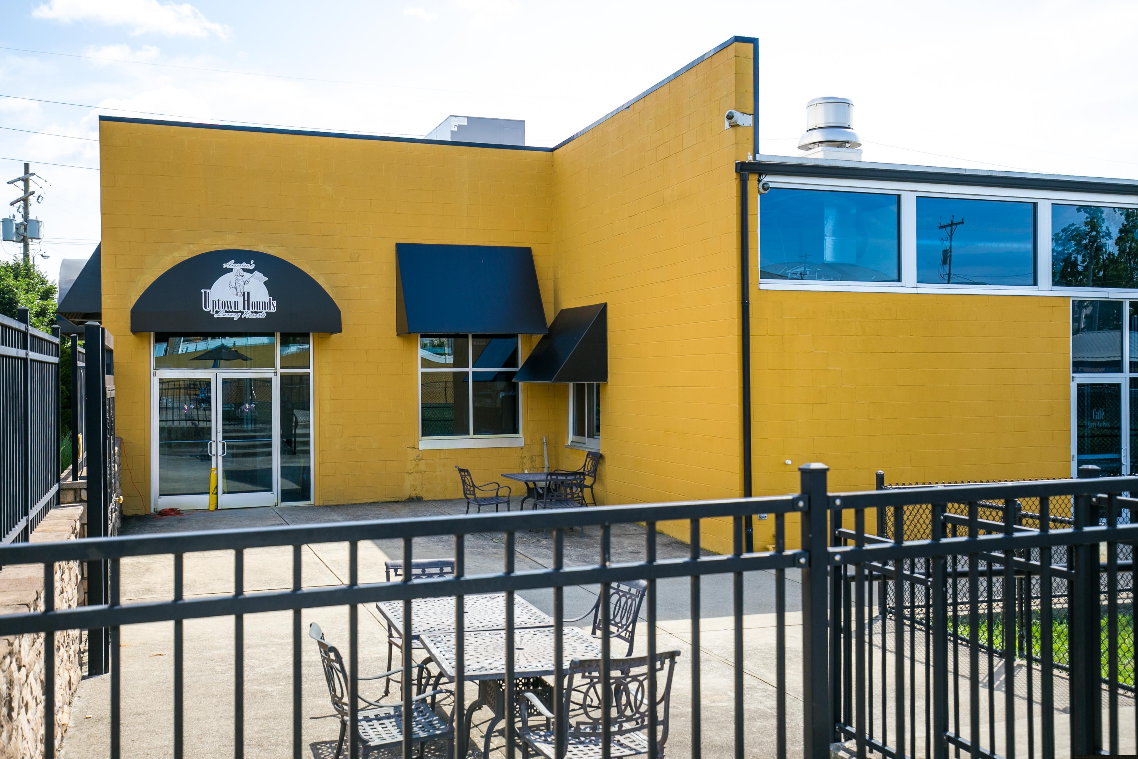 Uptown Hounds Exterior shot of their patio area. Picnic Tables and Chairs. 