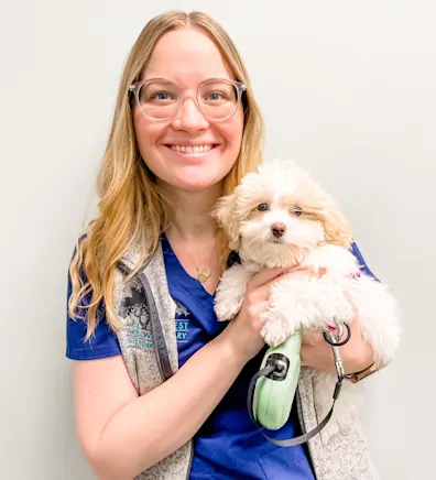 Heather Suhr smiling holding a small fluffy white dog Heather Suhr smiling holding a small fluffy white dog
