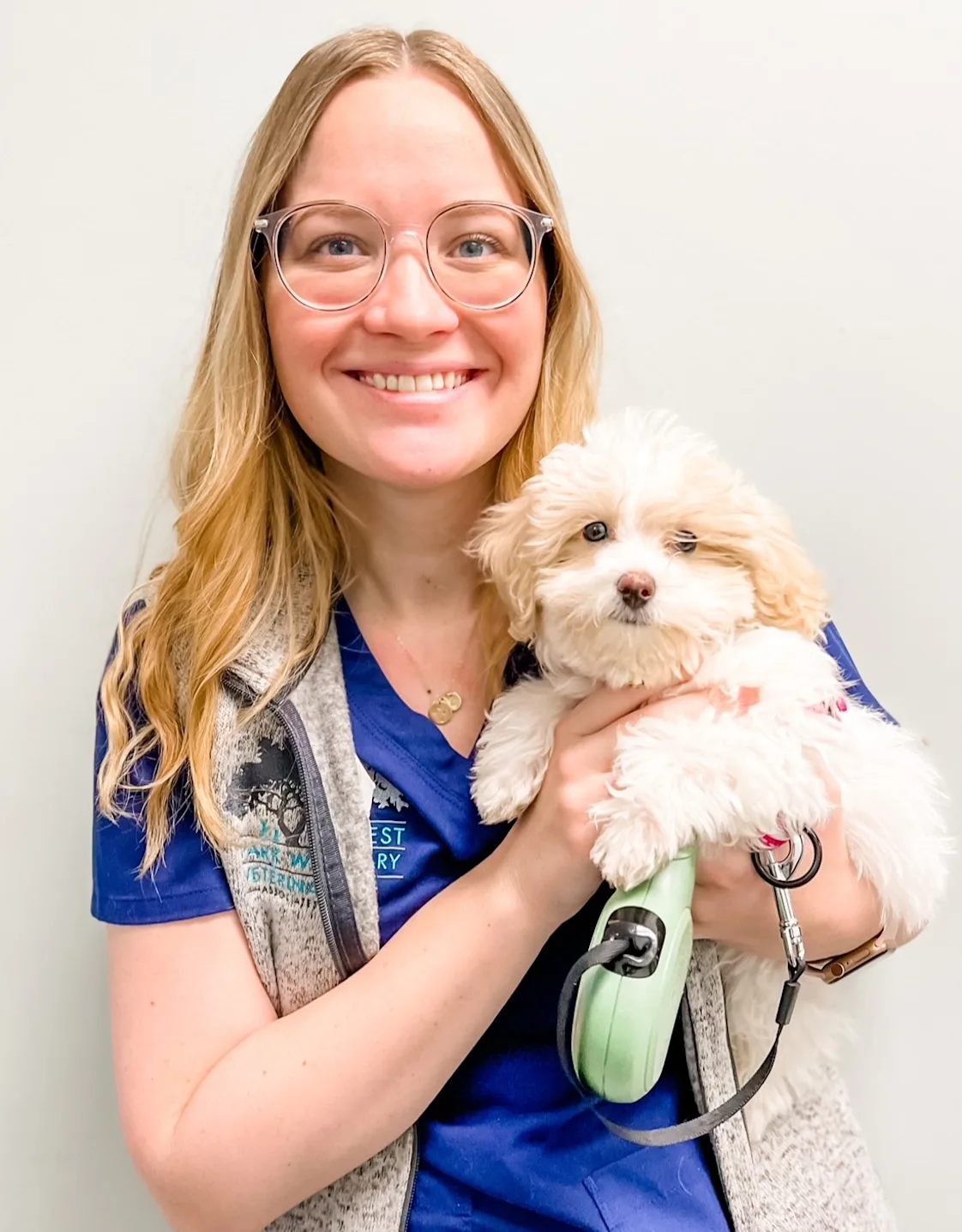 Heather Suhr smiling holding a small fluffy white dog Heather Suhr smiling holding a small fluffy white dog