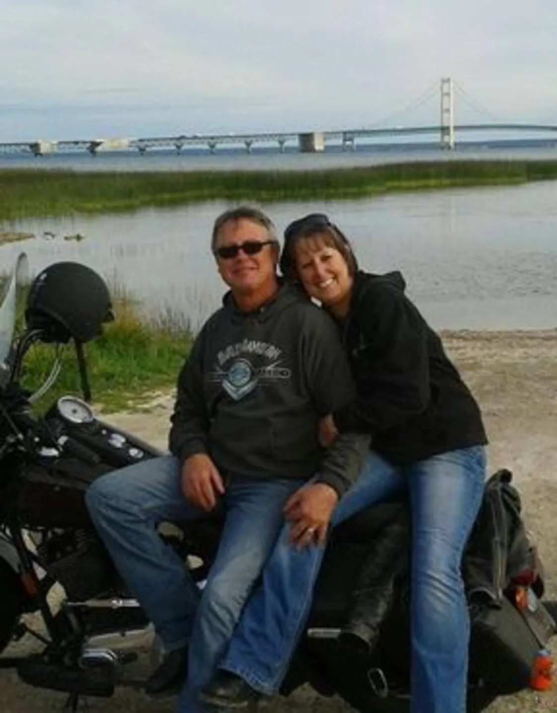 Lisa and her husband sitting on a motorcycle Lisa and her husband sitting on a motorcycle