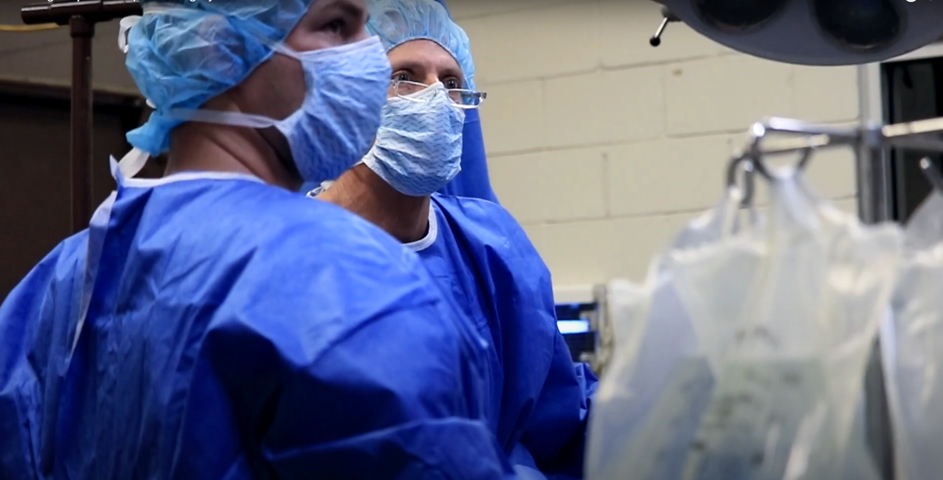 two surgeons looking up 