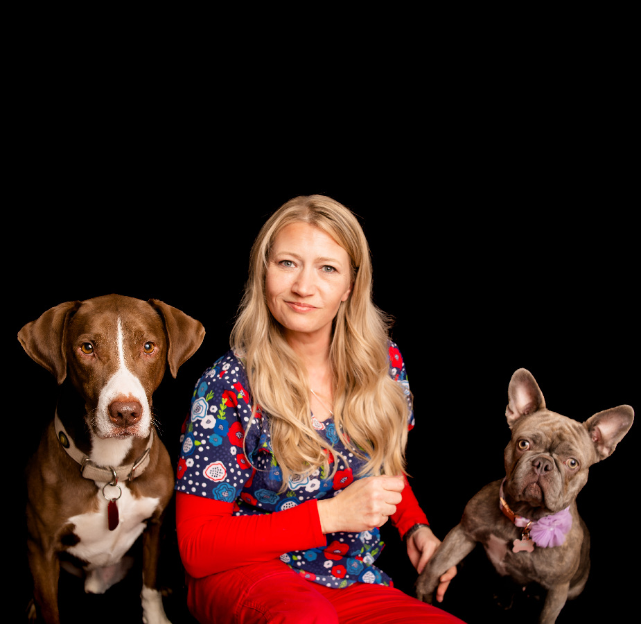 A Kindness Animal Hospital staff member with two dogs