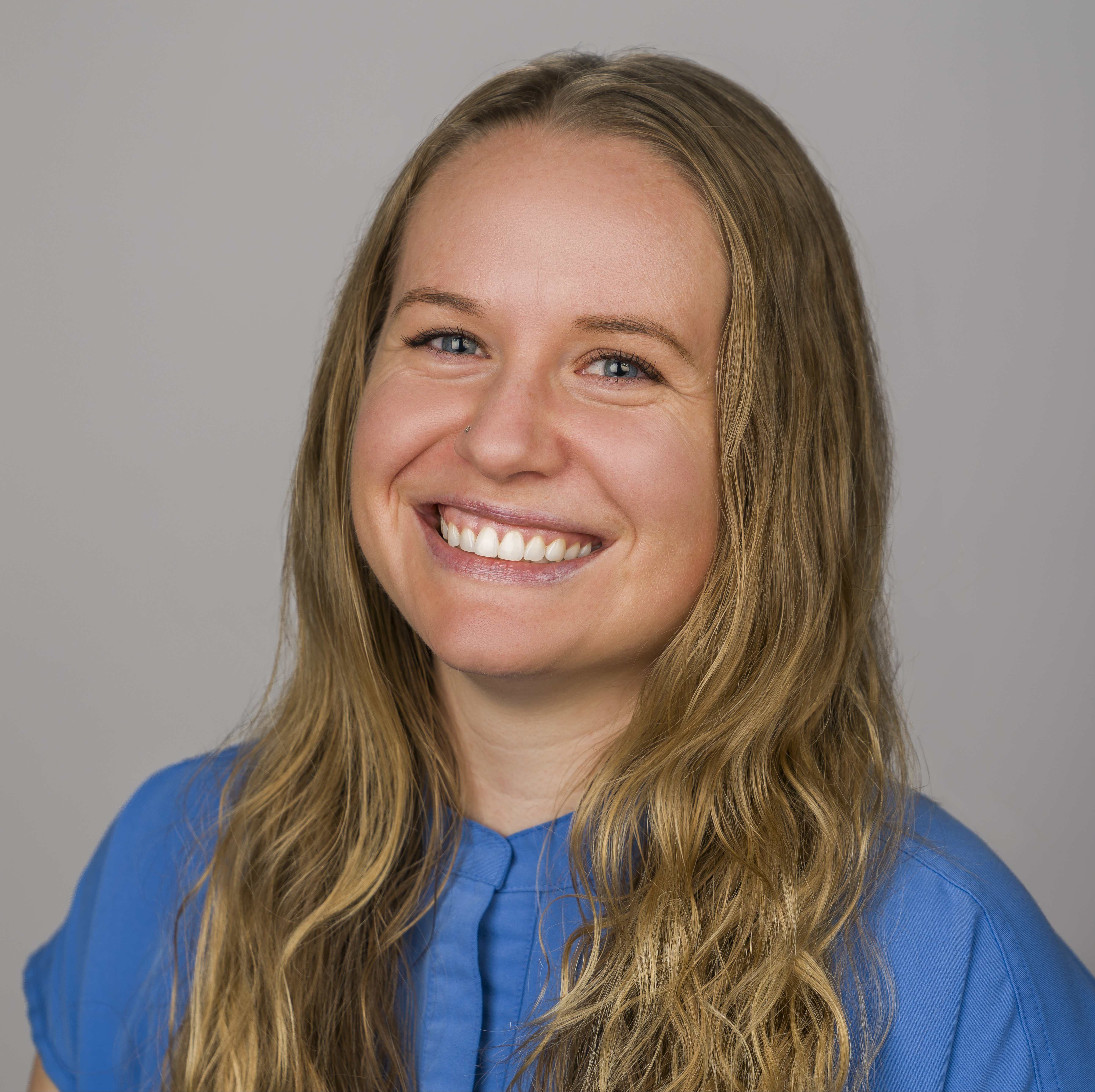 A photo of Dr. Hoff smiling in a grassy area