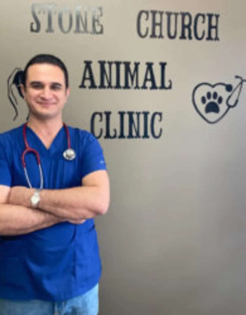 Dr. Saeid Ghiasi in front of the clinic sign