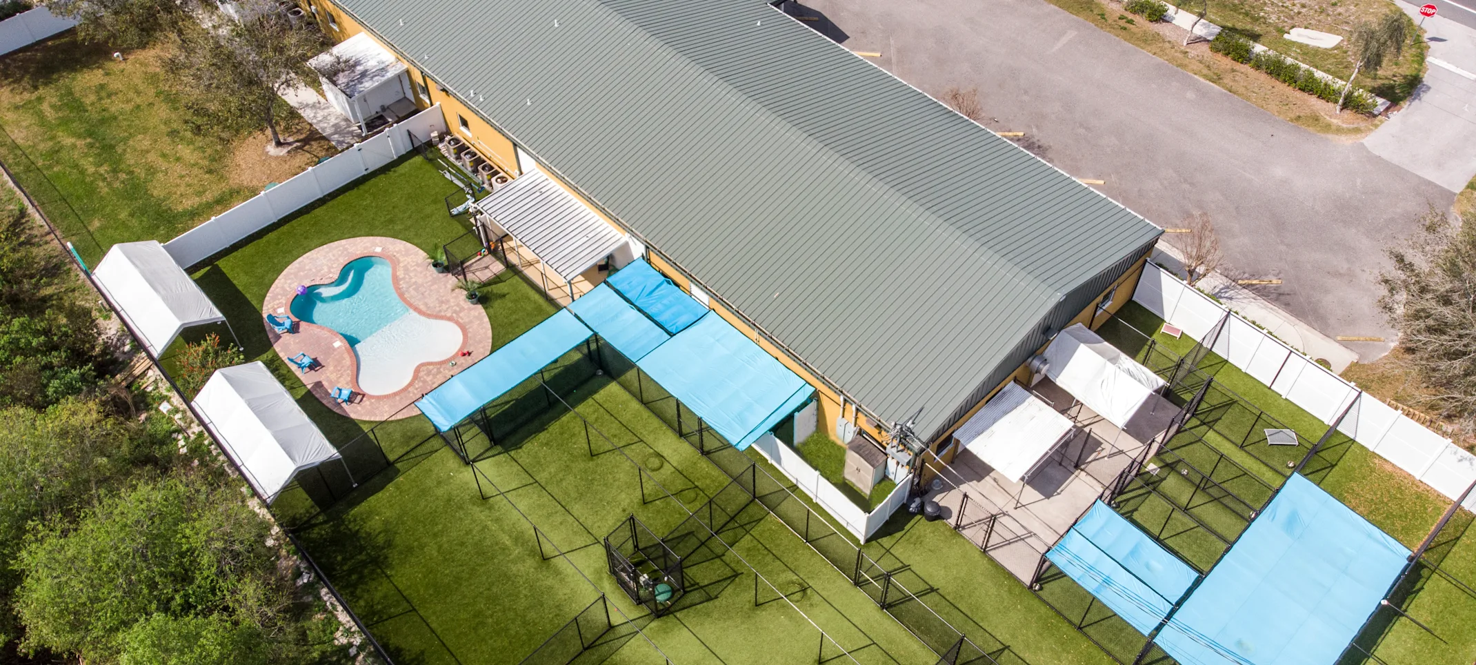 Overhead view of New Tampa Pet Resort building and play yards Overhead view of New Tampa Pet Resort building and play yards