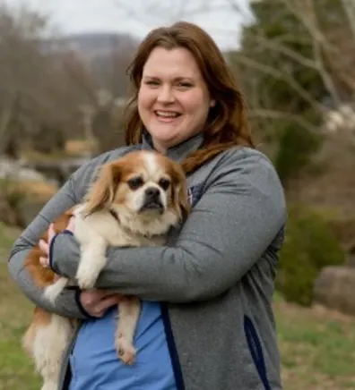Sara's staff photo from Valley Animal Hospital & Pet Resort where she is outside holding a small dog in her arms. Sara's staff photo from Valley Animal Hospital & Pet Resort where she is outside holding a small dog in her arms.