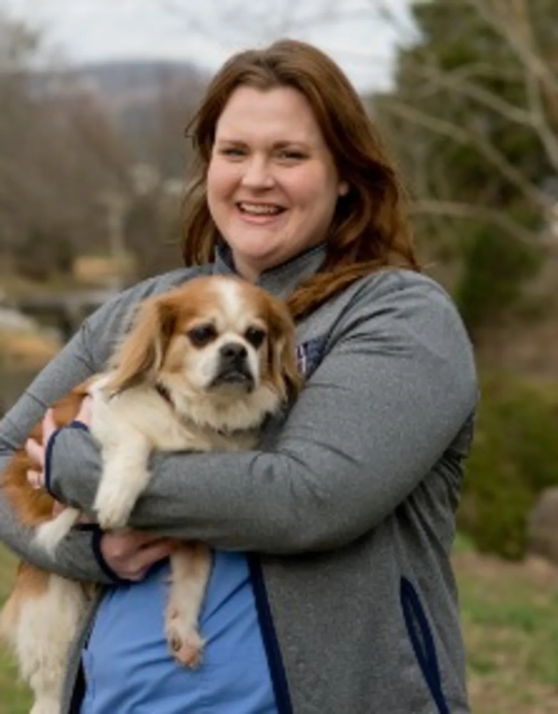 Sara's staff photo from Valley Animal Hospital & Pet Resort where she is outside holding a small dog in her arms. Sara's staff photo from Valley Animal Hospital & Pet Resort where she is outside holding a small dog in her arms.
