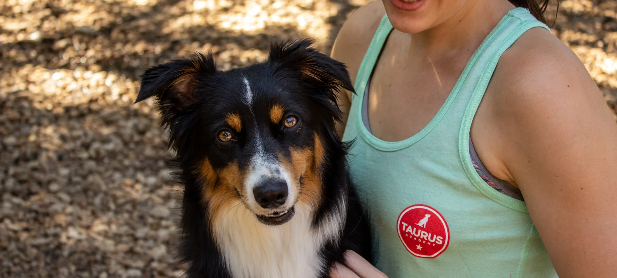 a woman holds a dog and smiles a woman holds a dog and smiles