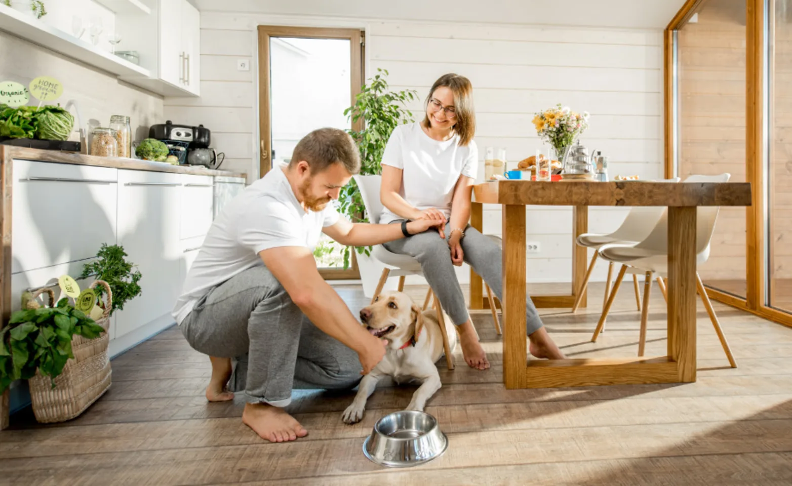 A Couple with their Dog at the Dining Table A Couple with their Dog at the Dining Table