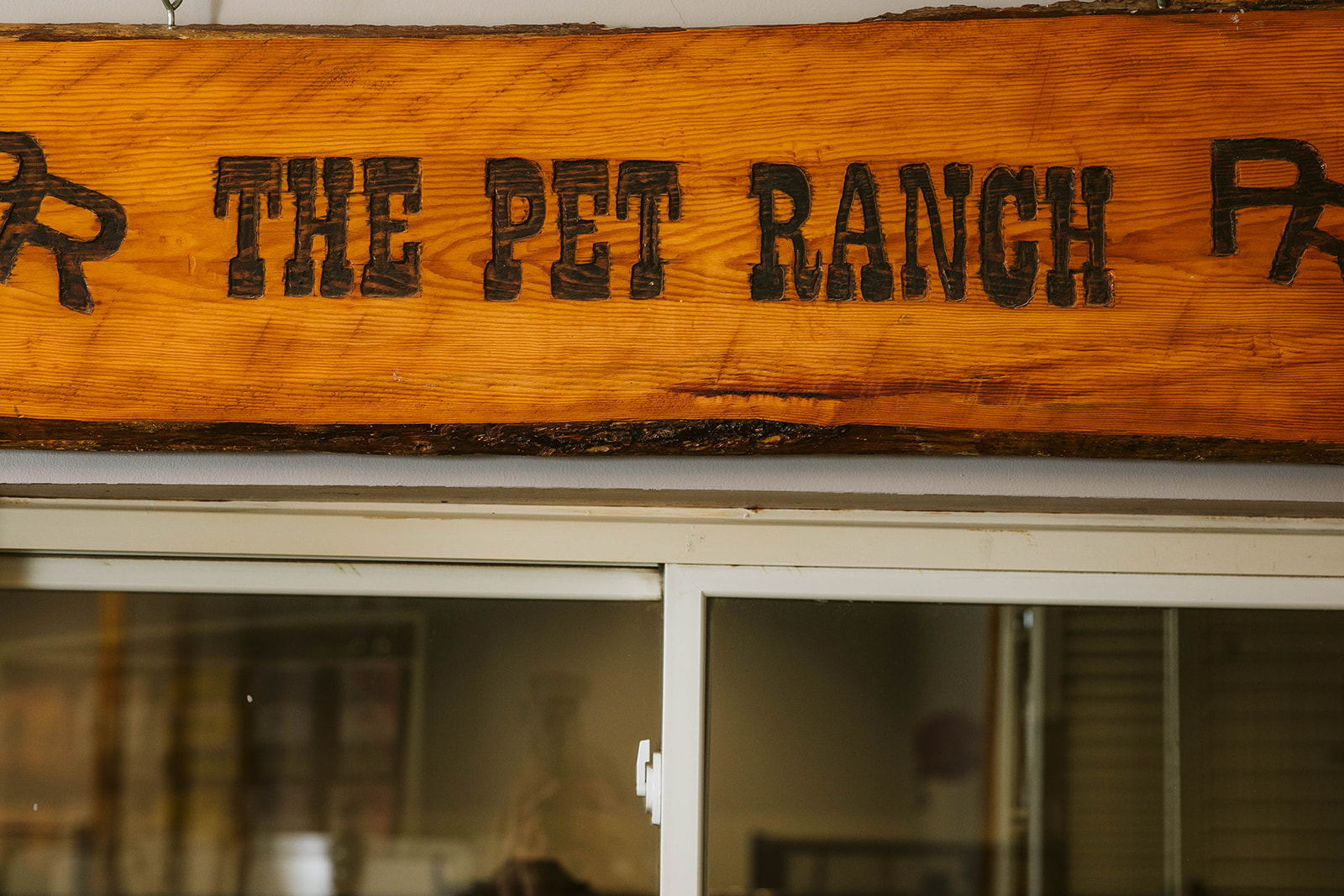 wooden sign that says "The Pet Ranch" in black text