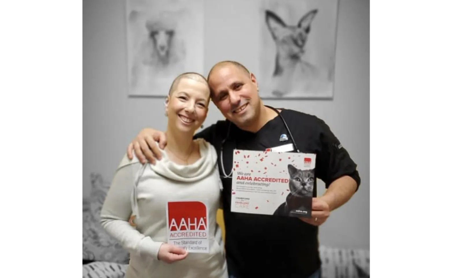 Dr Moshe and Noa Oz holding AAHA accreditations