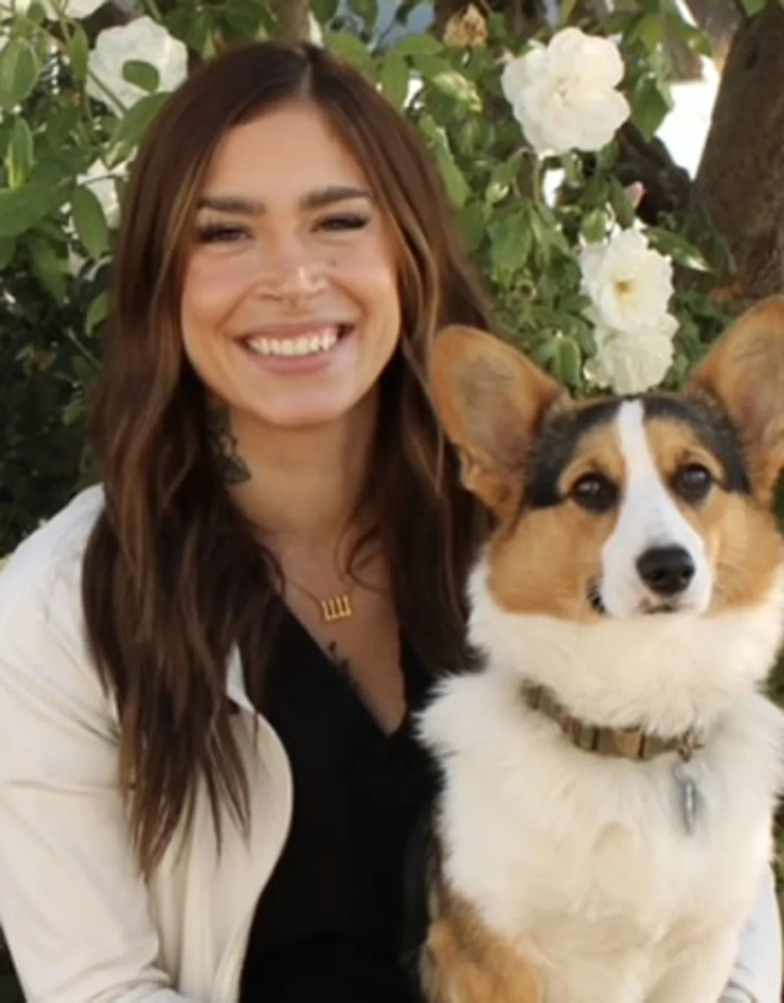 Woman staring at camera holding corgi Woman staring at camera holding corgi