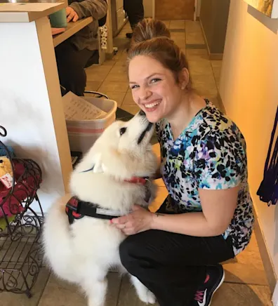 Harmony smiling next to a white dog Harmony smiling next to a white dog