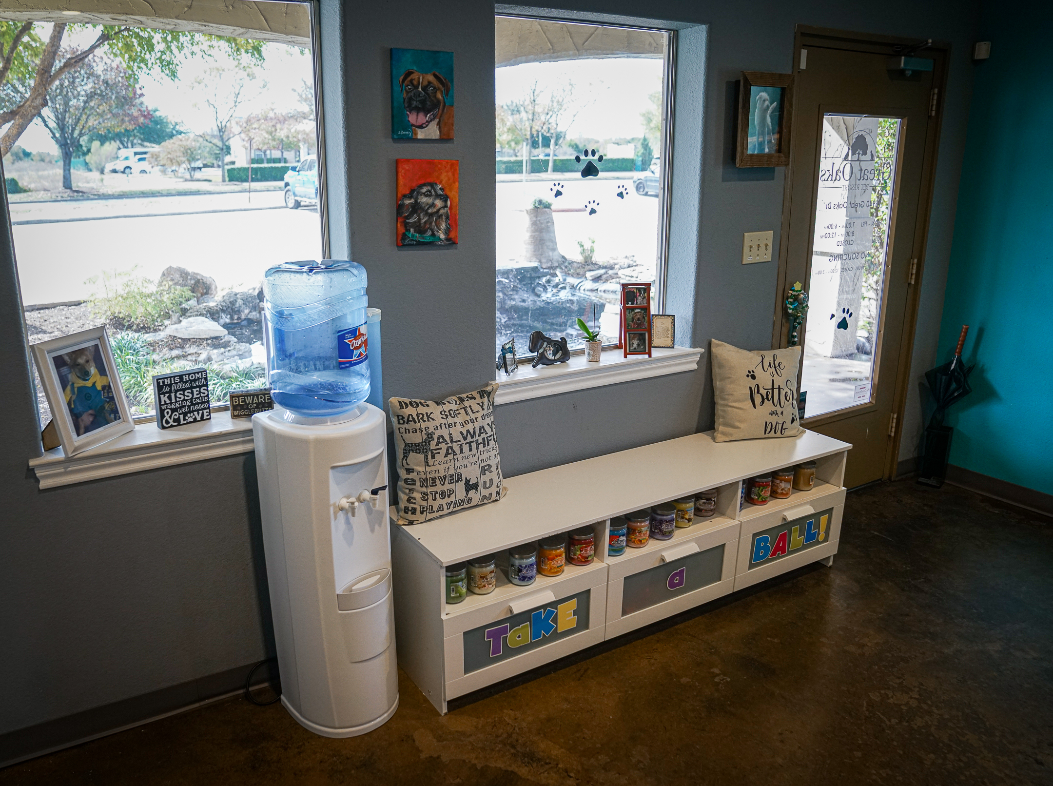 a bench and water cooler in front of the windows of Great Oaks Animal Hospital's lobby