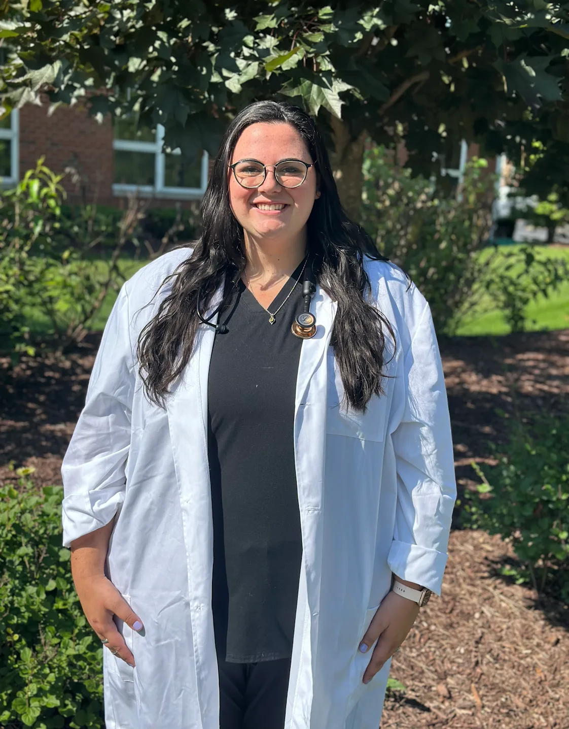 Dr. Lauren McKay standing outside wearing a white lab coat Dr. Lauren McKay standing outside wearing a white lab coat