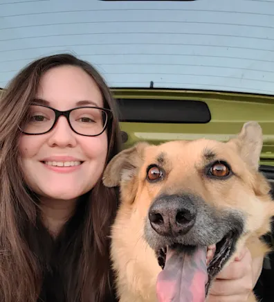 Erin, a Veterinary Assistant at Apollo North Animal Hospital, Holds a Dog Erin, a Veterinary Assistant at Apollo North Animal Hospital, Holds a Dog